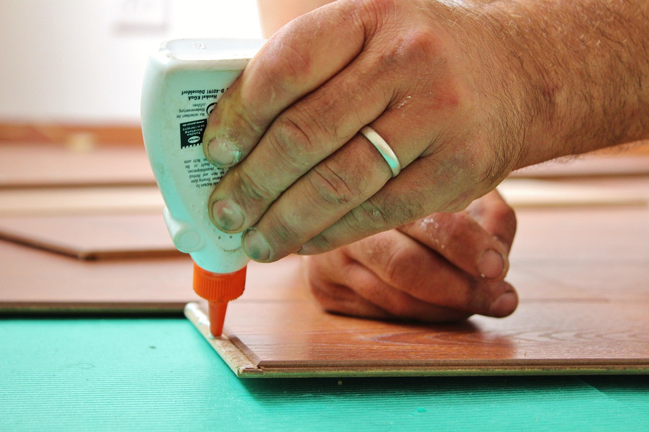 Craftsman applying wood glue during a home renovation joinery project